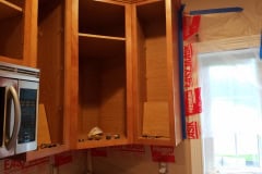 Cabinet doors removed and prepared for professional cabinet refinishing process in Groton Massachusetts
