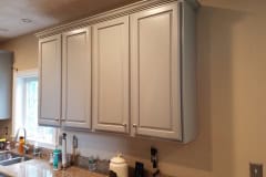 Kitchen cabinet painting project in Groton MA by Finish Masters Builders Corp showing professionally refinished cabinets with a smooth sprayed finish