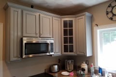Finished upper kitchen cabinets above stove with custom glass door lazy susan cabinet in Groton MA cabinet refinishing project