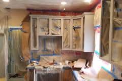 Kitchen cabinet carcass masked and taped off ready for spray finishing during cabinet refinishing project in Groton MA