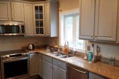 Completed kitchen cabinet refinishing project in Groton Massachusetts by Finish Masters Builders Corp