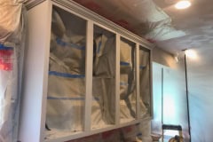 Upper kitchen cabinet carcass freshly sprayed with cabinet coating during refinishing project in Groton MA