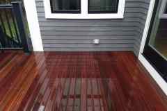 Beautifully restored wooden deck outside a modern home.