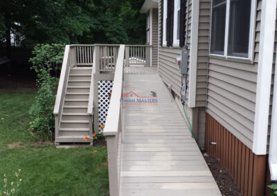 Exterior home renovation with new deck and siding by Finish Masters Construction & Painting.