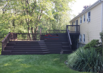 Custom outdoor deck built and painted by Finish Masters Construction & Painting.