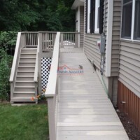 A newly built wooden deck and siding upgrade on a residential home by Finish Masters Construction & Painting. Exterior home renovation with new deck and siding by Finish Masters Construction & Painting.