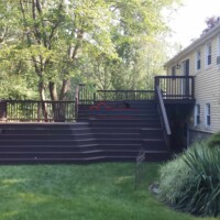 Newly constructed and painted backyard deck by Finish Masters, enhancing outdoor living space. Custom outdoor deck built and painted by Finish Masters Construction & Painting.