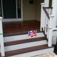 Porch renovation featuring fresh stain and paint, enhancing curb appeal and durability by Finish Masters Construction & Painting. Beautifully painted wooden porch with new stain and finish by Finish Masters Construction & Painting.