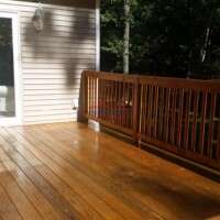 Quality deck staining and finishing services by Finish Masters Construction & Painting. Beautiful stained wooden deck with fresh finish and protective coating.
