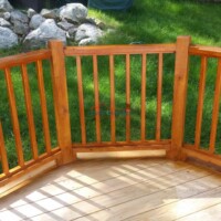 Professional wooden deck and railing installation by Finish Masters Construction & Painting. Outdoor wooden deck with railing installation.