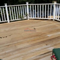 Deck renovation by Finish Masters Construction & Painting, showcasing a clean, polished wooden surface with a white railing for outdoor living. Beautiful wooden deck with white railing, completed by Finish Masters Construction & Painting.