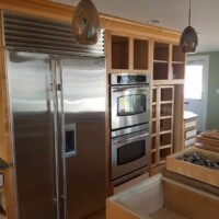 Modern kitchen with new cabinets, appliances, and fresh paint finish. Kitchen renovation with custom cabinetry and stainless steel appliances.