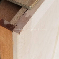 Up of a wooden wall corner during construction, showcasing quality craftsmanship and attention to detail. Interior wall construction and painting services.