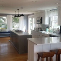 Quality interior painting services by Finish Masters Construction & Painting, showcasing a bright, clean kitchen and living space renovation. Interior kitchen and living room painting by Finish Masters Construction & Painting. Expert craftsma.