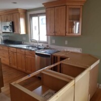 Modern kitchen with new cabinets and countertops, showcasing professional renovation services. Kitchen cabinet installation and painting by Finish Masters Construction & Painting.