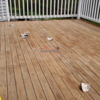 A beautifully refinished wooden deck showcasing professional painting and finishing by Finish Masters Construction & Painting. Newly refinished wooden deck with clean, smooth surface and safety features.