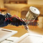 A painter applying a fresh coat of paint to a wooden door using a roller, showcasing quality craftsmanship and attention to detail. Professional painting services by Finish Masters Construction & Painting.