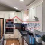 Modern kitchen with custom cabinets and professional painting services by Finish Masters. Quality kitchen renovation by Finish Masters Construction & Painting.