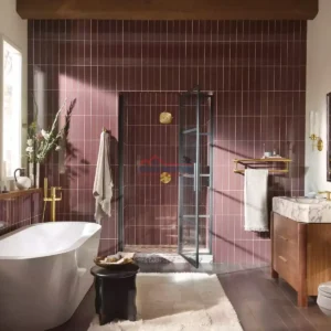 Luxurious bathroom featuring maroon tiles, a freestanding bathtub, and contemporary decor. Elegant bathroom with maroon tile walls and modern fixtures.