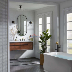 Luxurious bathroom with a freestanding tub, large windows, and contemporary decor. Elegant bathroom renovation with modern fixtures and stylish design.