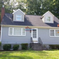 A beautifully painted house showcasing professional construction and painting services by Finish Masters. Exterior view of a freshly painted house by Finish Masters Construction & Painting.