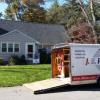 Professional painting crew working on a house exterior with a mobile paint trailer nearby. Residential and commercial painting services by Finish Masters. Expert craftsmanship for homes and b.