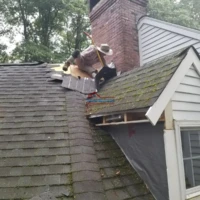 Roof repair and painting by professional contractors.
