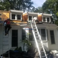 Renovation of a house with new roof and exterior painting.