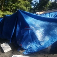 Blue tarp covering construction materials or equipment.