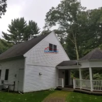 Exterior house painting and renovation services in progress.