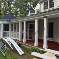 New porch construction with white railings and support columns.
