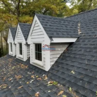 Expert roofing and painting services on residential homes with durable shingles.