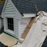 Exterior house painting and siding installation for a charming home.