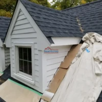 Exterior house painting and siding installation by Finish Masters.
