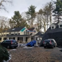 Exterior house painting and renovation project in progress.