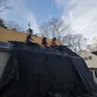 Roof repair by professional contractors in progress.