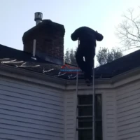 Chimney repair and roof painting by Finish Masters Construction & Painting. Expert exterior home ren.
