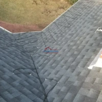 Professional roofing and painting services on a residential roof.