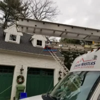Ladder truck parked outside a house during exterior painting project.