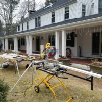 Exterior home renovation and painting project in progress.