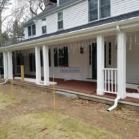 Exterior house painting and renovation services in progress.