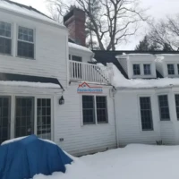Exterior house painting and renovation services in winter.