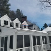 Exterior house painting and renovation services in progress.