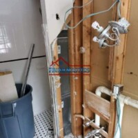 Bathroom wall demolition in progress for renovation by Finish Masters Construction & Painting. Demolition of bathroom wall for renovation by Finish Masters Construction & Painting.