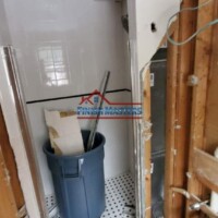 Bathroom renovation with construction tools and debris. Interior bathroom renovation in progress with construction tools and debris.
