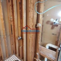 Bathroom renovation showing wall framing and plumbing installation. Remodeling bathroom with exposed wall studs and plumbing.