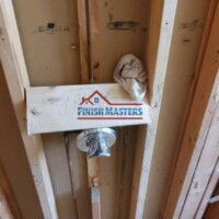 Interior wall framing with electrical setup at a construction site. Construction wall framing with electrical wiring in progress.