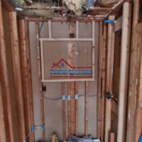 Interior bathroom renovation showing plumbing and framing work in progress. Bathroom renovation with plumbing and drywall installation.