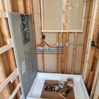 Interior bathroom framing with plumbing setup in progress. In framing and plumbing installation.