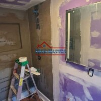 Interior renovation with drywall and painting work underway. Ceiling and wall drywall installation in progress.